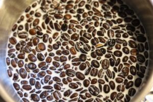 milk and coffee beans in a metal pan