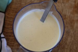 Classic Tutti Frutti Ice Cream Base. It is sat in a clear jug, with a silver and black spatula sat in the mixture.